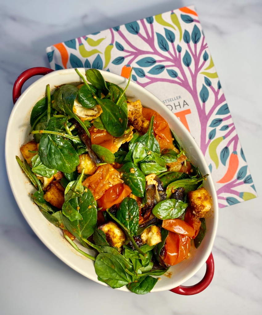roasted paneer and tomato with spinach in a tray